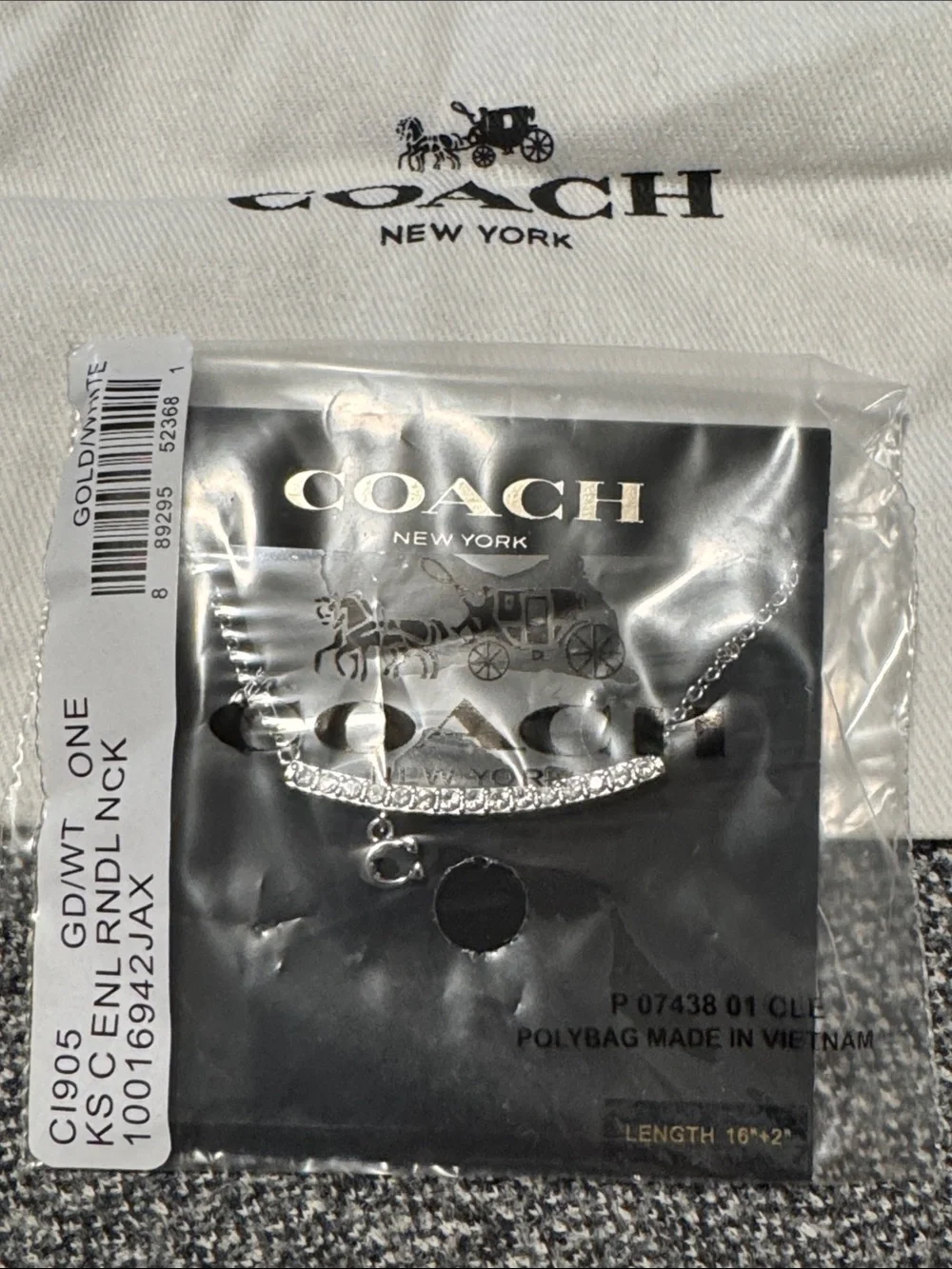 Coach Silver-Tone necklace with White Drawstring Pouch